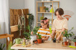 © Pixel-Shot - Cute children taking care of plants at table in workshop
