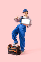 Wall Mural - asian female worker with laptop on pink background. mockup for design