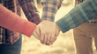 © Tossakan Photos - Hands joined together, symbolizing collaboration in business and education. A teamwork concept with soft focus and vintage tones, emphasizing unity and shared goals.
