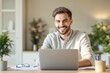 © Pixels Hunter - Smiling man working on laptop in cozy home office background with natural light.
