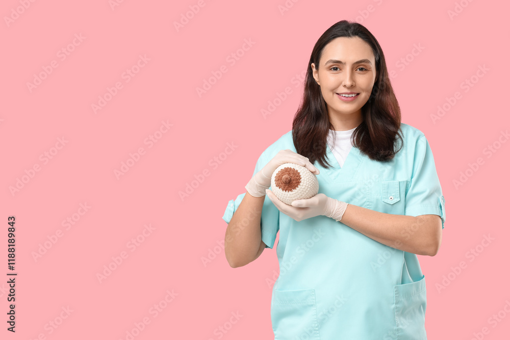 Female doctor with knitted breast model on pink background