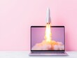 © Atmospheric stock - Rocket launching from laptop screen on pastel background