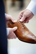 © Юля Бурмистрова - Shoemaker provides personalized service while fitting a customer with quality shoes in a welcoming retail environment