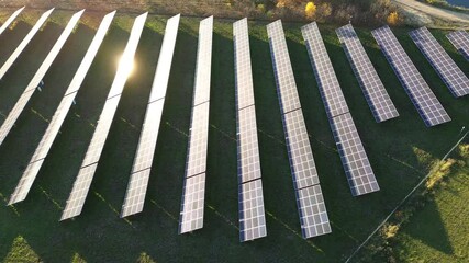 Wall Mural - Solar farm with bright sun reflection