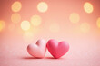 © He - Two pink hearts on glittery surface with bokeh style light background
