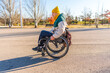 © unai - Young person using wheelchair enjoying stroll in park