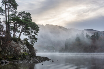 Wall Mural - Absolutely stunning dramatic atmospheric landscape image of Derwentwater during foggy sunrise in Autumn