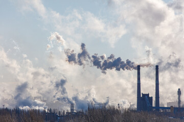 Wall Mural - A large cloud of smoke is rising from a factory