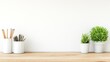 © milenialdesastudio - Minimalist workspace with pencils, plants, and a white wall.