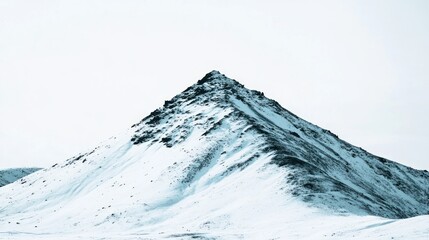 Wall Mural - snow-capped peak of a mountain against a white sky.