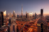 Aerial view of Burj Khalifa and Dubai downtown skyline at sunset, Dubai financial center, luxury skyscrapers and main traffic intersection. United Arab Emirates