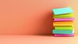 © Manon - A stack of colorful books rests against a peach-colored background, showcasing vibrant covers and a minimalistic design.