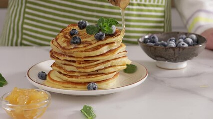 Wall Mural - honey pouring on stack pancakes breakfast food