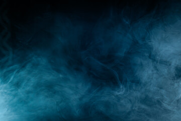 Abstract swirling blue smoke on a dark background, creating a mysterious and ethereal atmosphere. Perfect for artistic, moody, or creative designs.