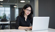 © Lightning - Professional Woman Working on Laptop in Modern Office