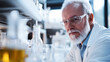 © mahamad - A senior male researcher conducting scientific experiments in a laboratory setting.