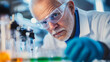 © mahamad - A senior male researcher conducting scientific experiments in a laboratory setting.