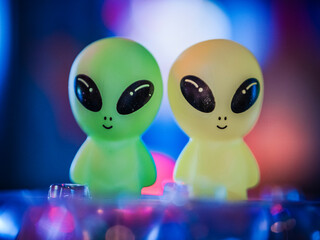 Two alien toys stacked over cocktails