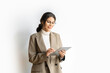 © Stock 4 You - Smiling young middle eastern Israel businesswoman using tablet pc online application for work isolated on white background. Indian or arabic woman in business suit holding digital computer. Copy space