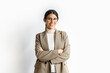© Stock 4 You - Portrait of middle eastern Israel businesswoman, business lady standing with crossed arms isolated on white background. Smiling young Arabian or Indian woman in suit, looking at camera, copy space