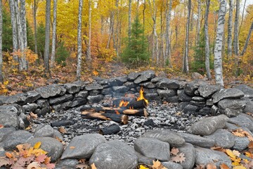 Wall Mural - Autumn Campfire in a Forest Clearing Tranquil Outdoor Gathering Spot Surrounded by Vibrant Fall Foliage