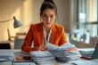 © Vadym - Businesswoman in orange blazer searches for document in stack of paperwork on desk in office. Busy work environment with piles of papers, laptop. Professional woman focused on finding important