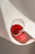 © Canvas Alchemy - Elegant glass holding red beverage