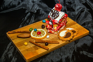 Beautiful and tasty fruits and candies lie on the board on a dark background