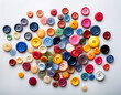 © Vitali - A scatter of multi-colored buttons creating a playful and creative contrast against a white background.