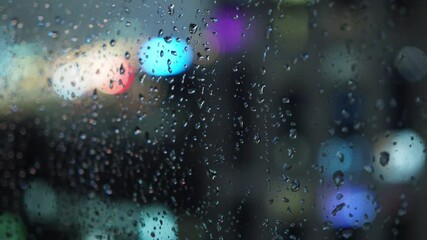 Wall Mural - raindrops on the window against the blurred background of the night city bokeh effect