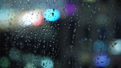 Wall Mural - raindrops on the window against the blurred background of the night city bokeh effect