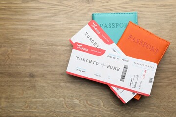 Sticker - Travel agency. Flight tickets and passports on wooden table, top view. Space for text