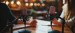 © zhuan - Women Podcasting with Microphones and Laptops in a Cozy Home Studio Setting