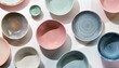 © Jay Nandu - Top view of craft ceramics with soft pastel glazes, surrounded by minimal shadows, positione