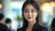 © Jaturong - A woman in a black business suit is smiling for the camera. Generative AI