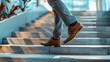 © Molly P - A business person confidently walking up the stairs, showcasing elegant footwear and formal attire. Ideal for themes of professionalism and career growth.