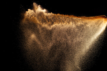 Wall Mural - Sand flying explosion isolated on black background ,throwing freeze stop motion object design.