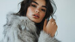 © mahamad - A model posing in a faux fur jacket.