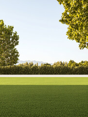 Wall Mural - Lush green lawn under clear sky with distant mountains and trees in the background