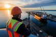 © munirahsamsudin - Engineer Overseeing Ship Movements at Port During Sunset