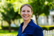 © Austockphoto - Happy businesswoman employee smiling for headshot portrait outside