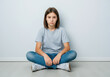 © Rizka - Sad Teenager Girl Sitting on Floor
