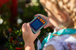 © Austockphoto - Young child outside with kids digital camera taking a photo of plant in garden