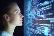 © DigitalMagicVisions - Profile view of a woman focused on coding a responsive website with digital data visualizations illuminating her face and expression of concentration