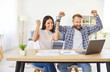 © Studio Romantic - Enthusiastic young couple win, happy celebrate good news, success online, spouses getting bank notice, loan approval, job offer, commercial proposal, overjoyed at home, watching game, comedian movie