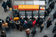 © Oleh Marchak - Long line of people waiting to withdraw cash from ATMs in a busy urban area during a chilly afternoon