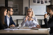 © fizkes - Businesswoman, company boss explains contract details to shareholders, sit at conference table, make speech, provide information, share opinion and strategy, engaged in teamwork activity. Negotiations