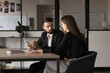 © fizkes - Two young Caucasian teammates involved in dialogue in meeting room, to sharing ideas, creative thoughts and business vision, gathered for decision-making, take part in productive teamwork in office
