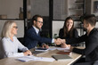 © fizkes - Two business parties shaking hands greeting each other start negotiations in board room, express mutual respect, thanking for cooperation, successful teamwork, establish partnership in company office