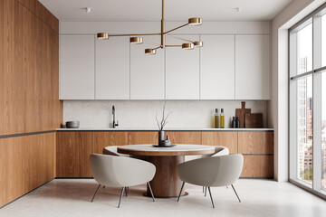 Wall Mural - Modern kitchen interior with wooden cabinets, round table, and elegant chairs under a stylish chandelier, overlooking urban skyline. 3D Rendering